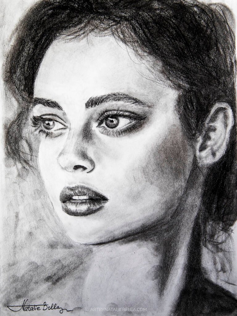 Striking graphite and charcoal portrait of a woman with expressive eyes and detailed features. Beautiful realism in black and white.