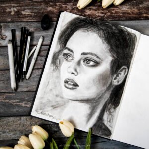 Striking graphite and charcoal portrait of a woman with expressive eyes and detailed features. Beautiful realism in black and white.