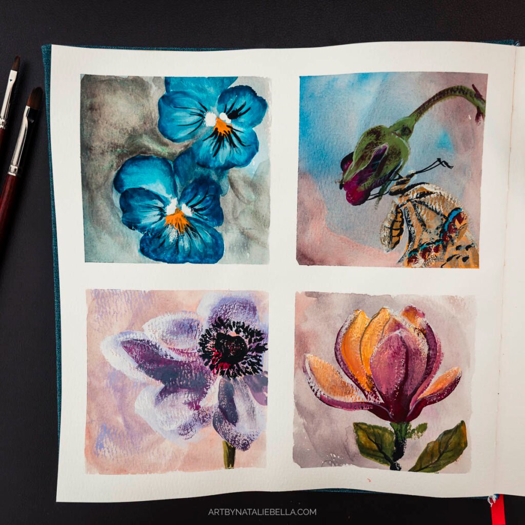 Four gouache flower paintings in open sketchbook showing blue pansies, butterfly, purple bloom, and orange magnolia on white paper