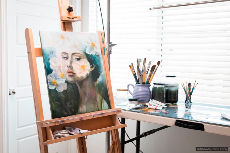 Oil painting of woman with white daisies on wooden easel in bright art studio with paintbrushes, ceramic vessels, and natural window light