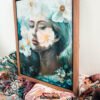 Where Ethereal Dreams Bloom - Original oil painting on canvas by Natalie Bella featuring a dreamy portrait of a woman surrounded by white flowers with golden centers against a soft teal background, contemporary mixed media art, 16x20 inches