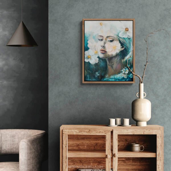 Where Ethereal Dreams Bloom original oil painting by Natalie Bella in walnut frame displayed in modern Scandinavian living room with gray walls, natural wood console table, ceramic vase with branches, and neutral decor - contemporary woman portrait with white flowers