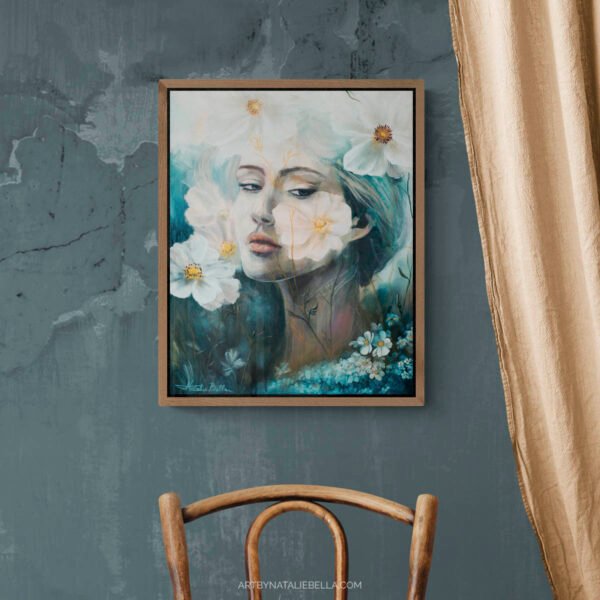 Where Ethereal Dreams Bloom original oil painting by Natalie Bella in walnut float frame displayed on textured blue-gray wall above vintage wooden chair with art books and white planter, showing ethereal woman portrait with white flowers in rustic home decor setting
