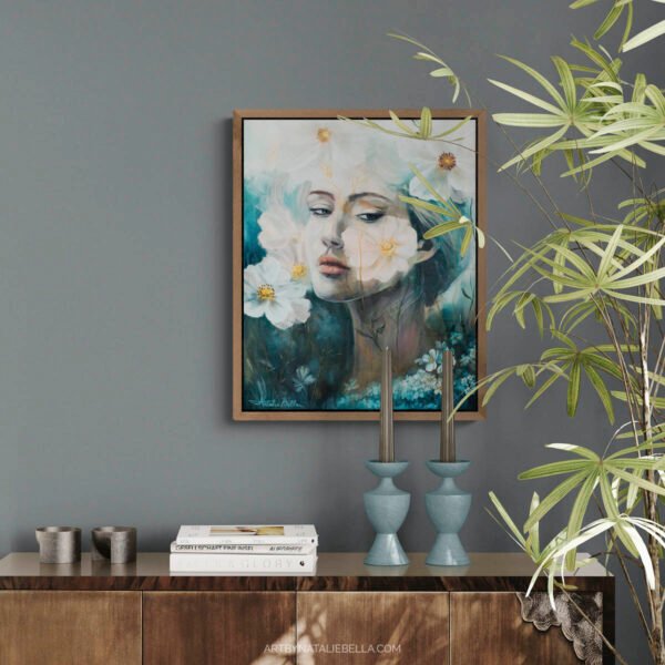 Where Ethereal Dreams Bloom original oil painting by Natalie Bella displayed in modern living room with walnut float frame, featuring ethereal woman portrait with white flowers on gray wall above wooden credenza with blue candlesticks and spider plant