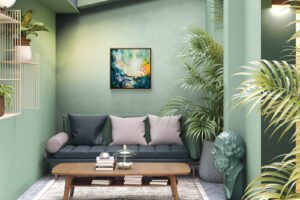 Original 24x24 teal abstract painting Awakening by Natalie Bella in a warm wood float frame on a sage green wall above a dark sofa, surrounded by tropical plants in an eclectic botanical living room