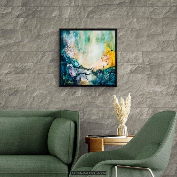 Awakening - Teal Abstract Painting in Modern Living Room by Nata Original 24x24 teal abstract painting Awakening by Natalie Bella displayed in a black float frame above a green sofa in a contemporary living room with stone wall, showing scale and interior styling