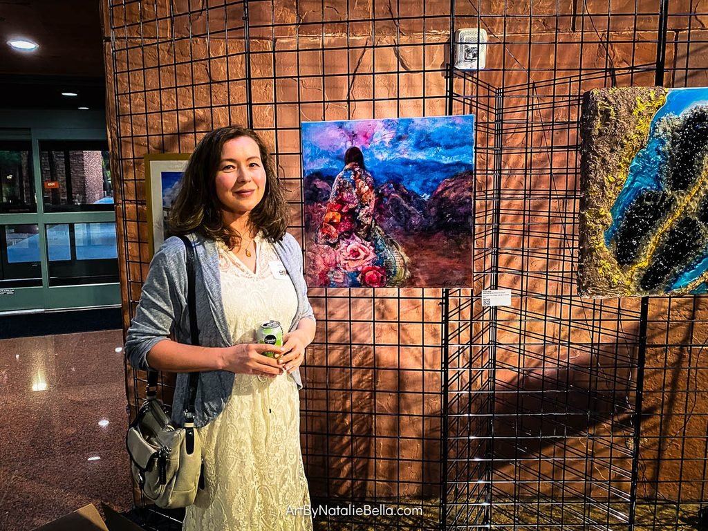 Artist Natalie Bella with her artwork at the BE HOME SOON reception